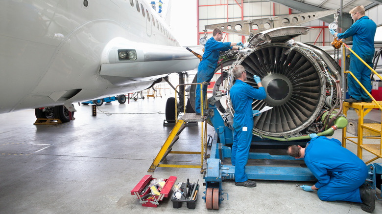 Engineers working on an engine