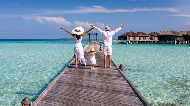 family on a dock in the Maldives