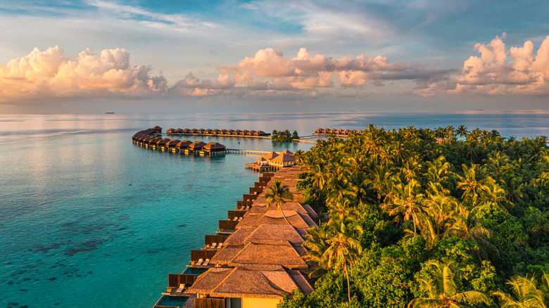 an aerial shot of a resort and bungalows in the maldives
