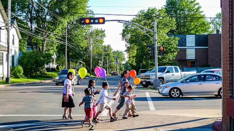 Family crossing the street in Prince Edward Island, Canada, with view of traffic light