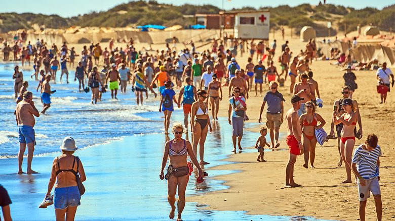 Crowds of holidaymakers on a resort beach in the Canary Islands