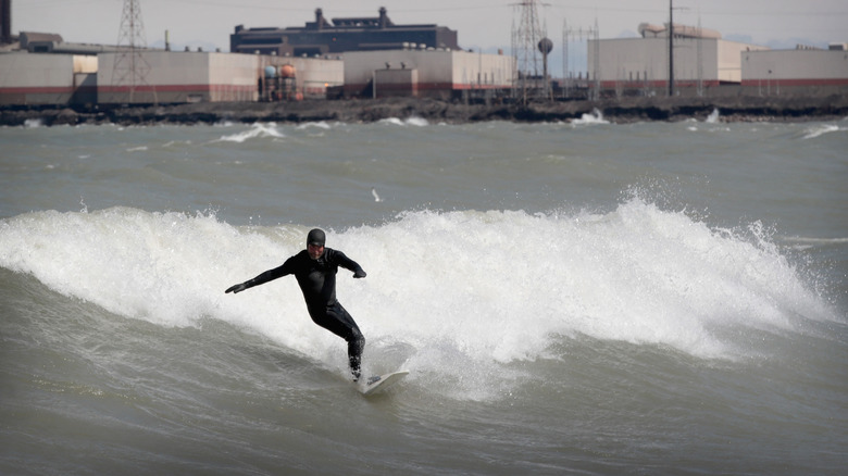 A surfer rides the waves on Lake Michigan, in Whiting, Indiana