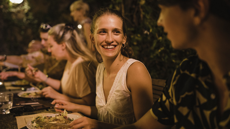 Woman enjoying Italian dinner with friends