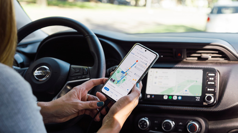 Person connecting their phone to a rental car navigation system