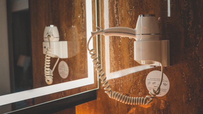 Wall-mounted white hotel hair dryer