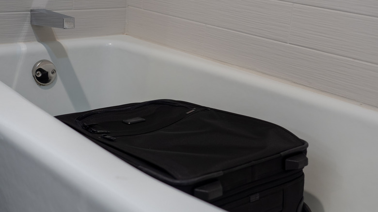 Suitcase in a bathtub at a hotel