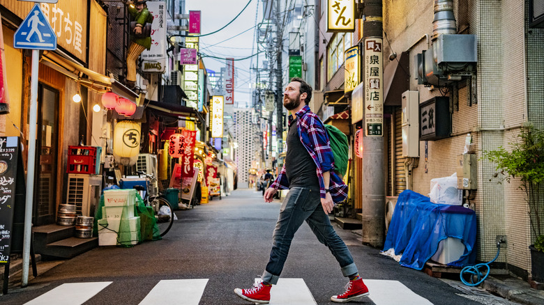 man crossing street japan