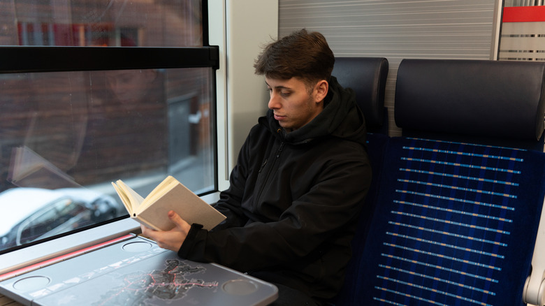 A man reading on a train