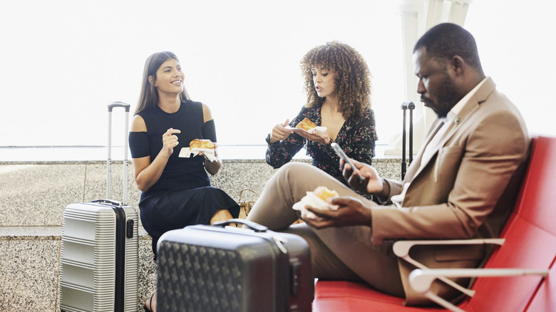 Friends eating at an airport