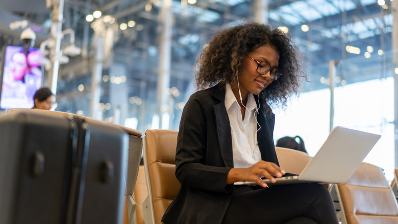 Woman working on a laptop at the airport