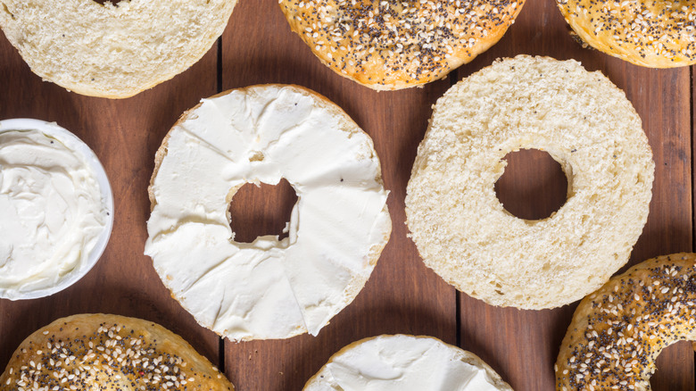 A row of bagels with cream cheese
