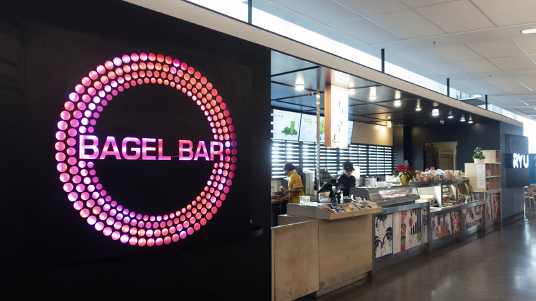 Two ladies working behind counter of Bagel Bar at terminal of Montreal International Airport