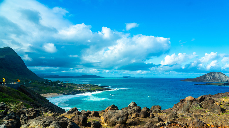 The coast of Hawaii with blue waters and volcanic hills
