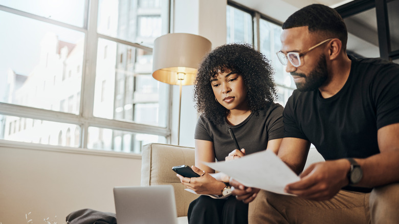 A couple checking their finances