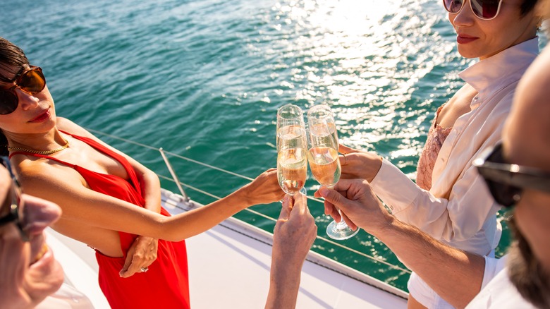 group toasting champagne on a boat