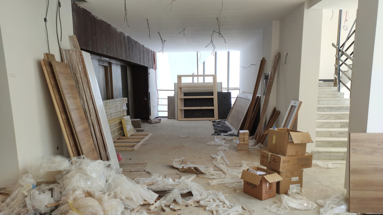 An under construction room filled with building materials and waste