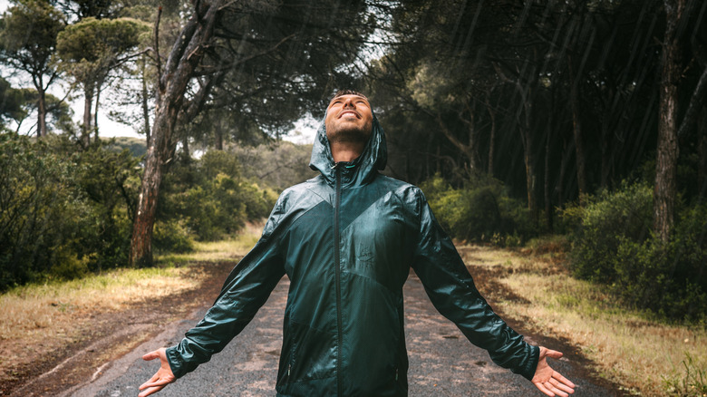Person standing in the rain and looking up
