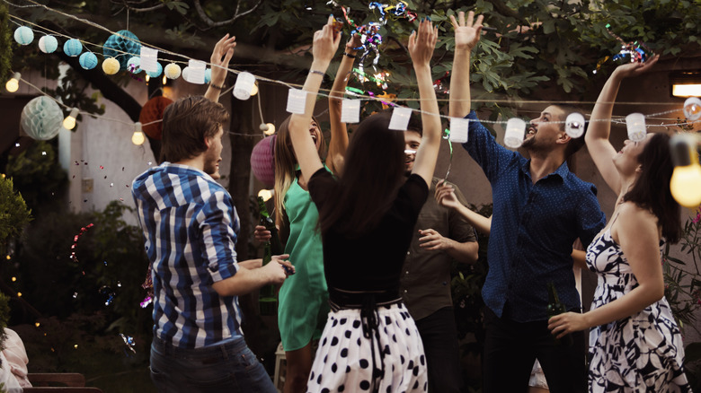 People partying in the yard at an Airbnb
