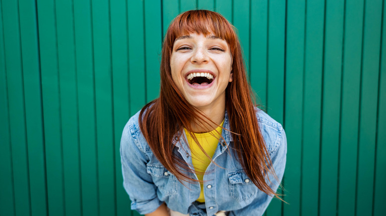 Woman smiling with green background