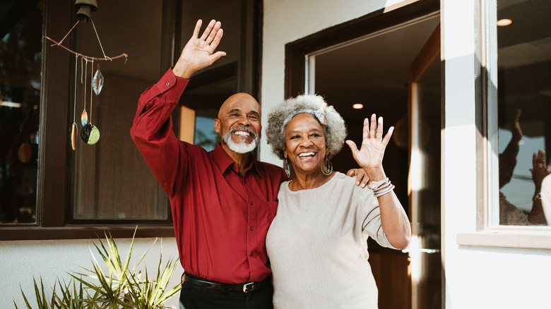Elderly couple waving