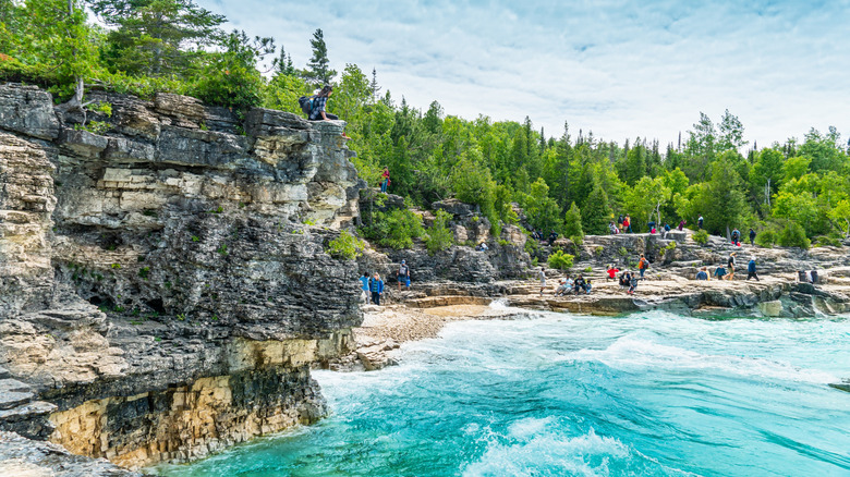 Visitors explore the limestone cliffs of Bruce Peninsula National Park in Ontario, Canada.