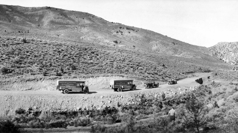 Trucks driving cross-country along dirt road