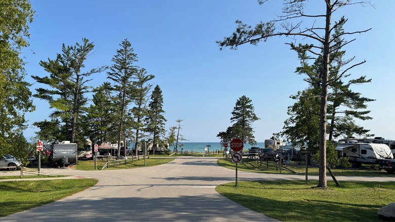 The paved road branching off the the modern campsites at Wilderness State Park with Lake Michigan on the horizon