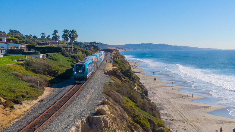 Amtrak train on cliff overlooking a California beach