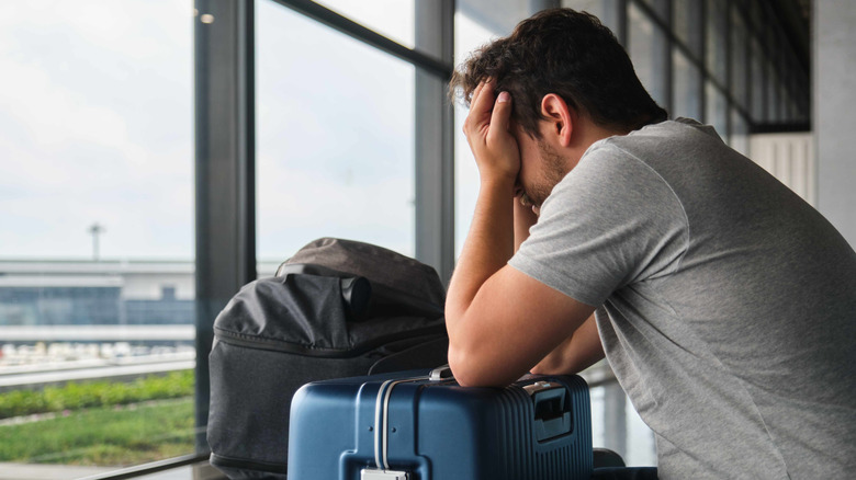 Traveler with luggage upset at the airport