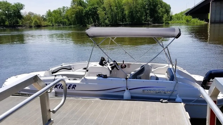 A boat docked at William G, Stratton State Park in Illinois, surrounded by calm waters and greenery.