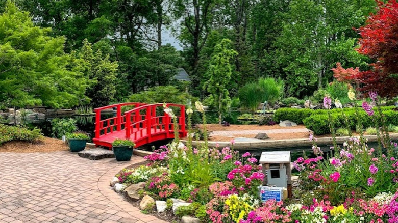 A red bridge crosses a pool in the New Hanover County Arboretum, North Carolina