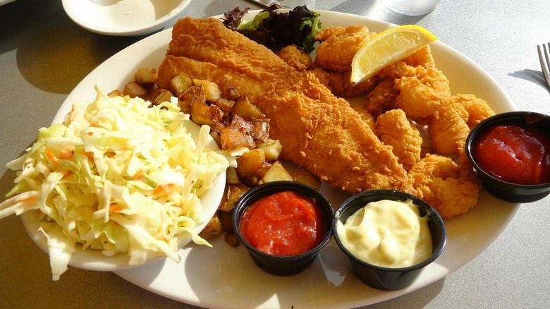 Plate of deep fried catfish with coleslaw and dipping sauces at River 128