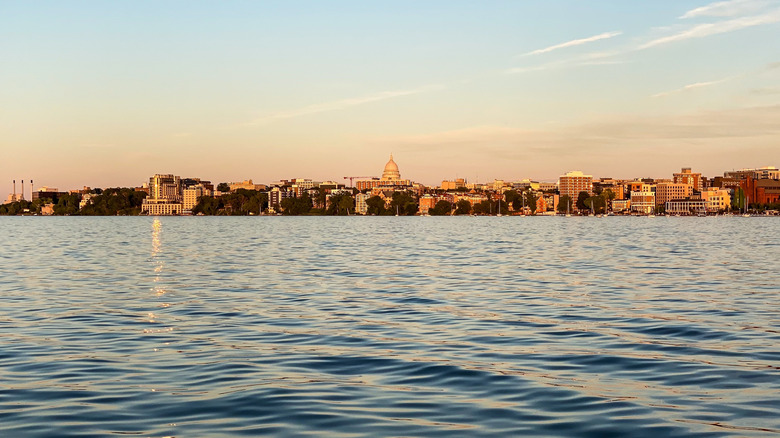 The Madison Wisconsin city skyline at sunset from on the water of Lake Mendota