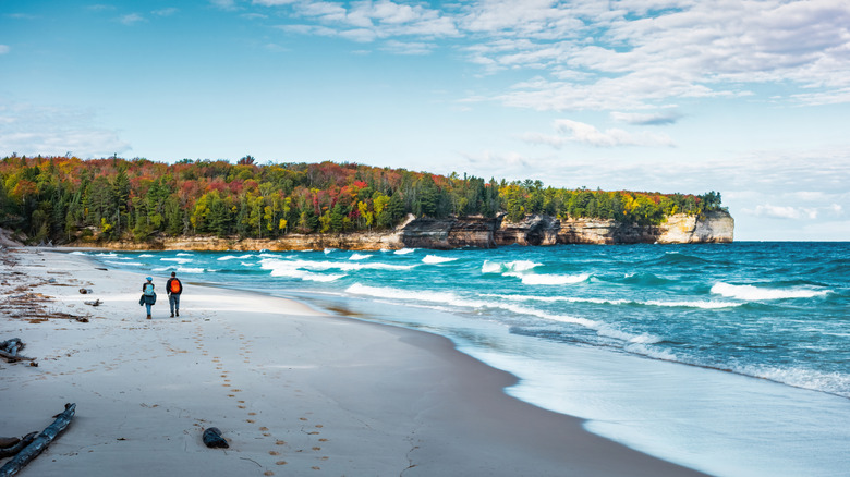 Couple walking on a Lake Superior beach at Pictured Rocks National Lakeshore in Michigan