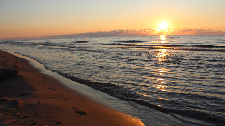A sunrise over the water at Kohler-Andrae State Park