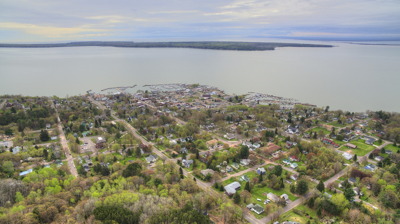 Aerial view of Bayfield, a small town with houses and trees on a large lake