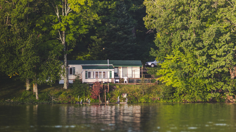 Cabin nestled in a forest facing a lake in Hayward, Wisconsin