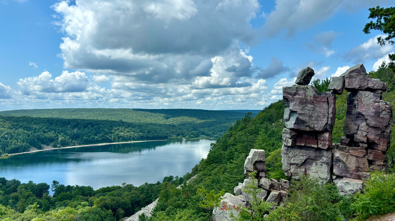 The quartzite outcroppings of Devil's Lake with the calm lake below and rolling forests in the distance
