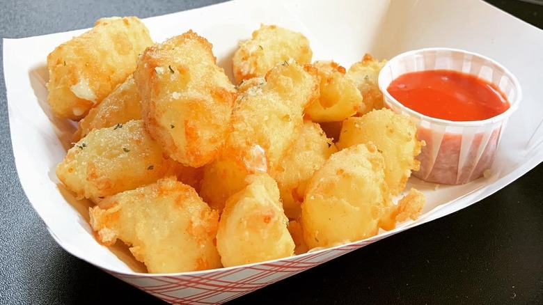 basket of cheese curds with ketchup