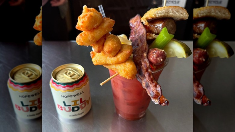 a can of beer and a bloody mary piled high with cheese curds from West Allis Cheese and Sausage Shoppe in Milwaukee