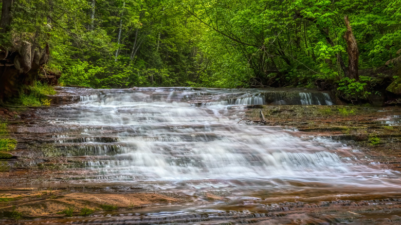 Waterfall and natural slide in forest