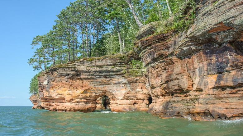 Cliffs on lakeshore with a hole in the rock