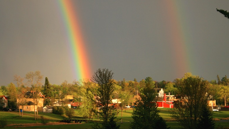 Rainbows over houses and landscapes of Grantsburg, Wisconsin