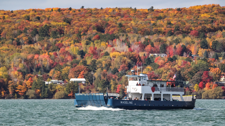 a ferry crossing a lake in the fall