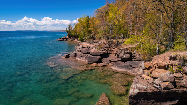 a rocky shoreline of a large lake
