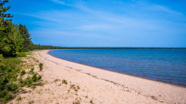 a sandy beach along a big lake