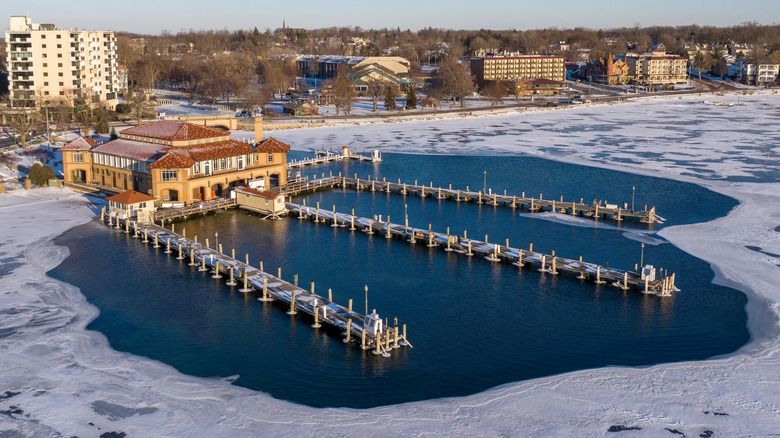 Drone shot of boathouse and frozen marina on Lake Geneva in Wisconsin