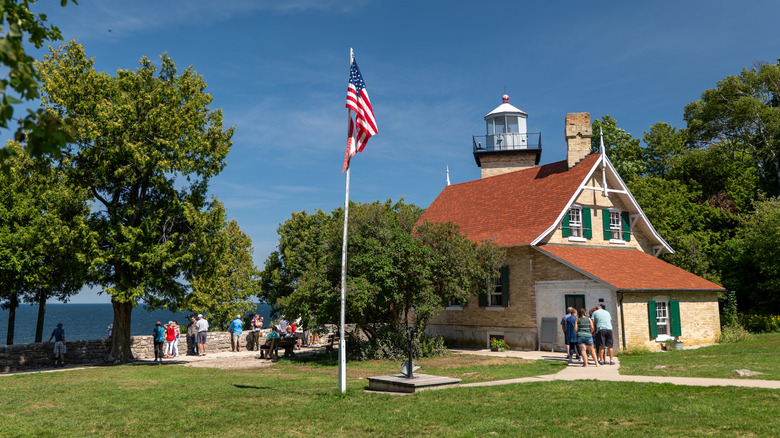 Historic lighthouse with American flag outside