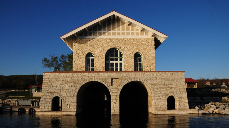 A stone boathouse on a lake's edge