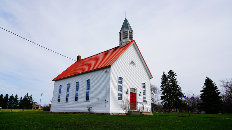 Small white church with red roof and steeple near Denmark, Wisconsin